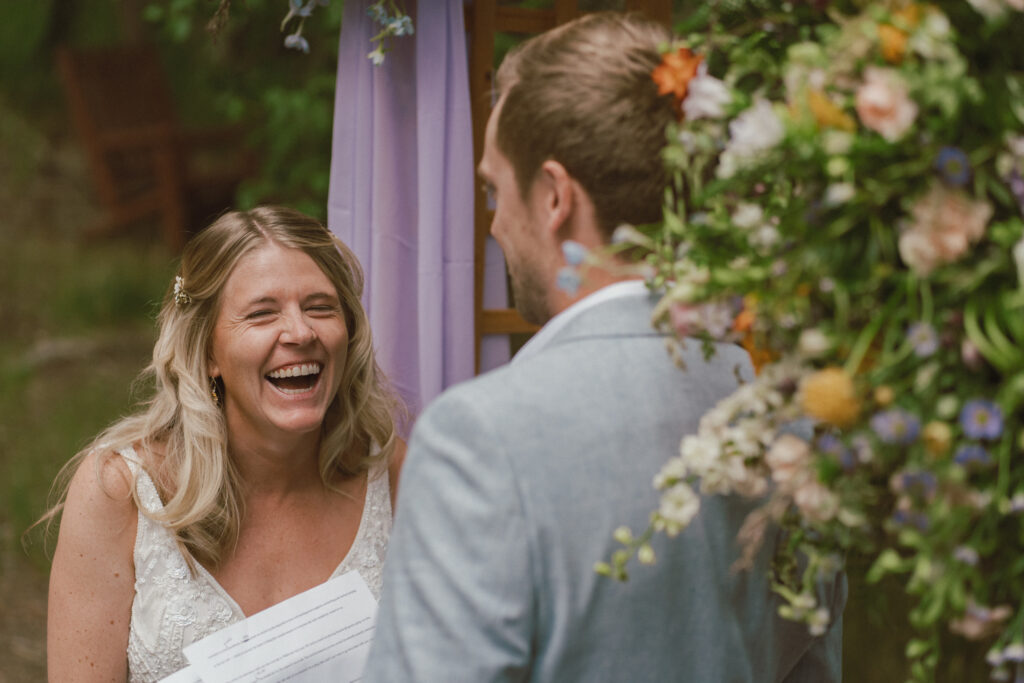 Bride laughing during wedding ceremony taken by a documentary style wedding photographer