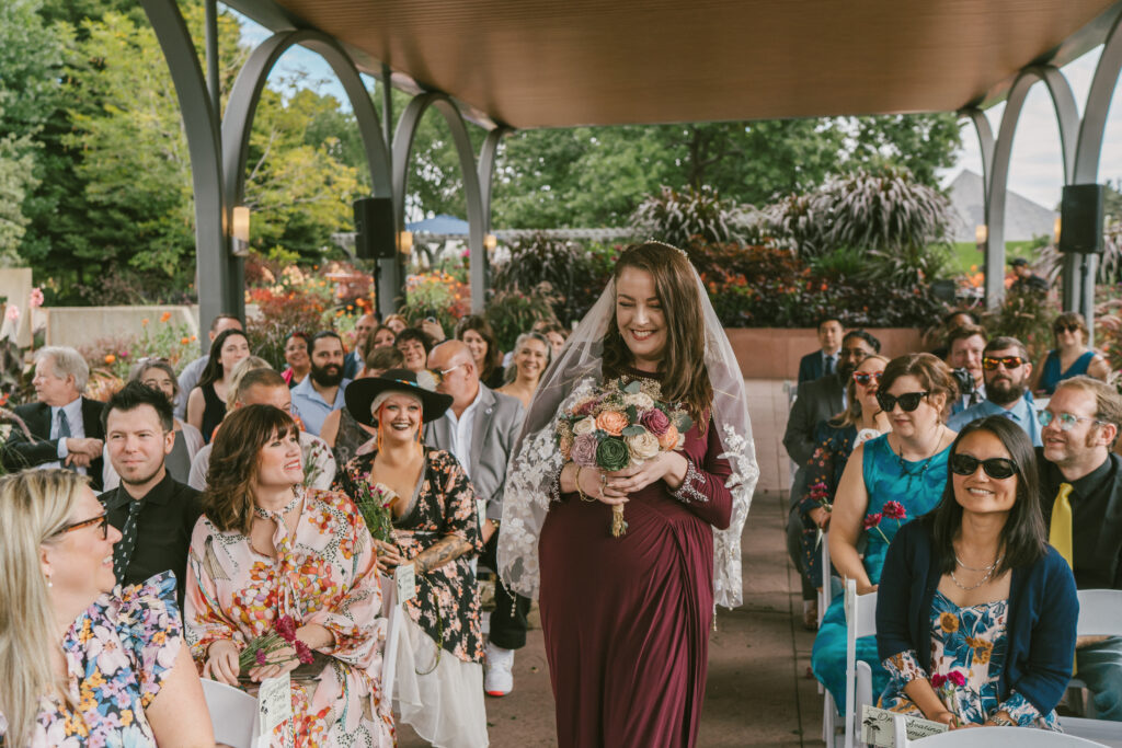 Bride walking down the aisle at wedding at Denver Botanic Gardens