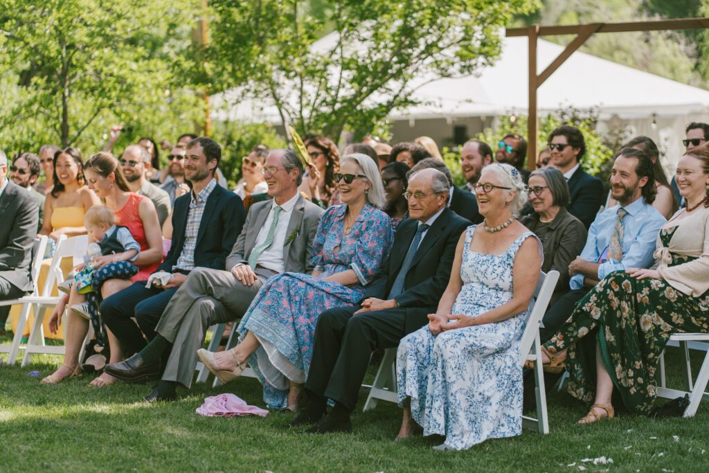 Wedding guests laughing at a Colorado wedding venue ceremony