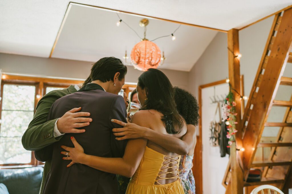 Wedding guests hugging at a Colorado wedding venue