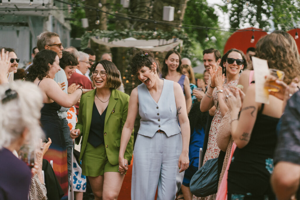 Lesbian couple exiting ceremony at a Colorado wedding venue